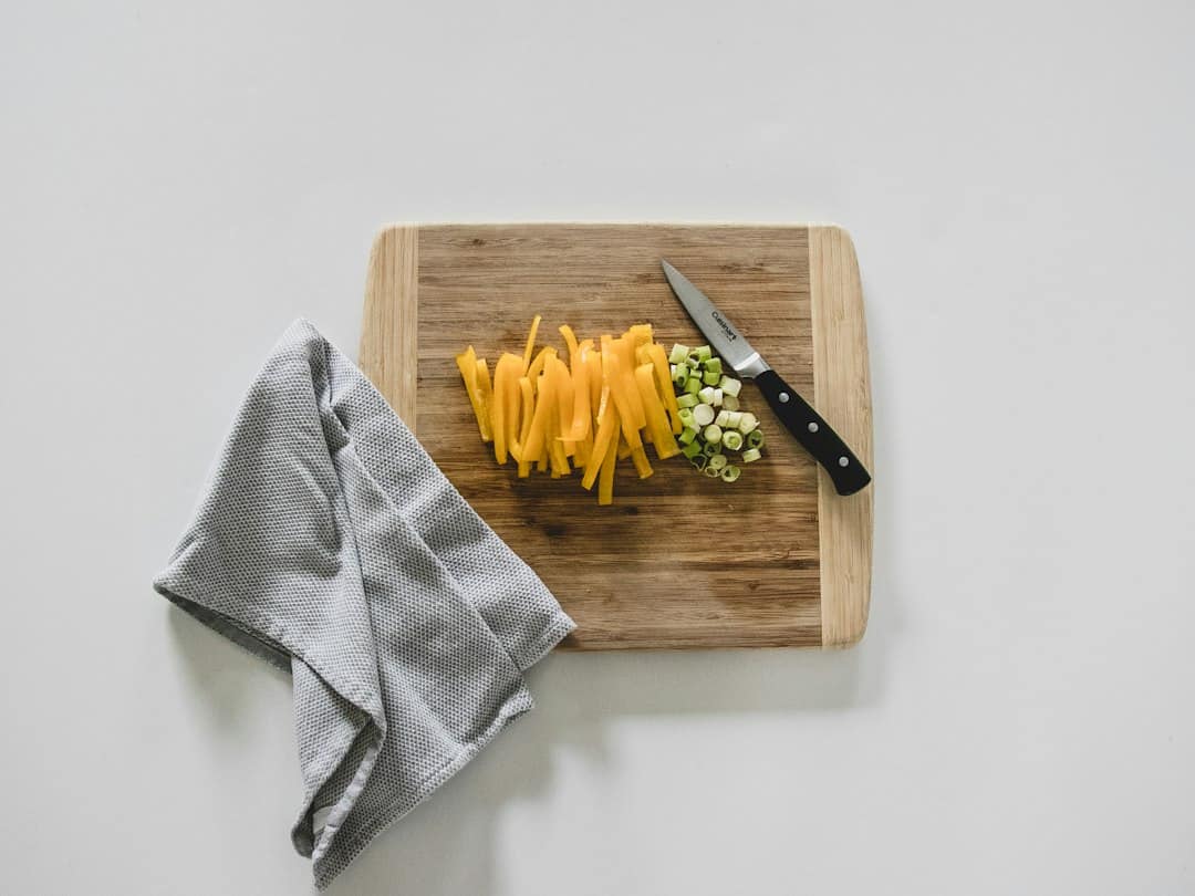 Cutting vegetables on a wooden board in a home kitchen