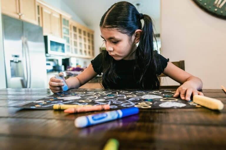 Child painting at a table during a homeschool art lesson
