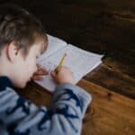 Child working on a math worksheet at home